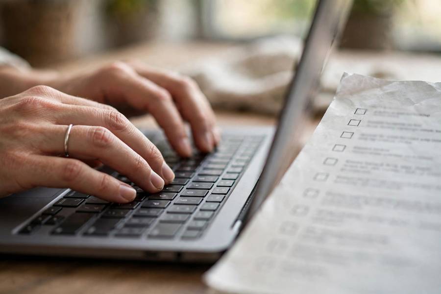 Hands working through an AI compliance checklist on a laptop