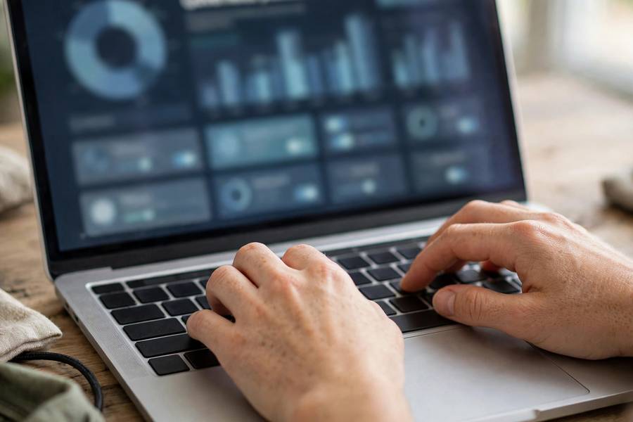 Hands on keyboard with an AI governance platform interface on screen