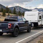 AWD vs 4WD for Towing: Which Pulls Better and Safer? 4WD truck towing a travel trailer, comparing AWD vs 4WD for towing