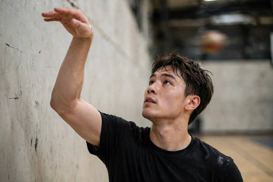 Photorealistic close-up of a player with perfect follow-through during a wall shooting drill