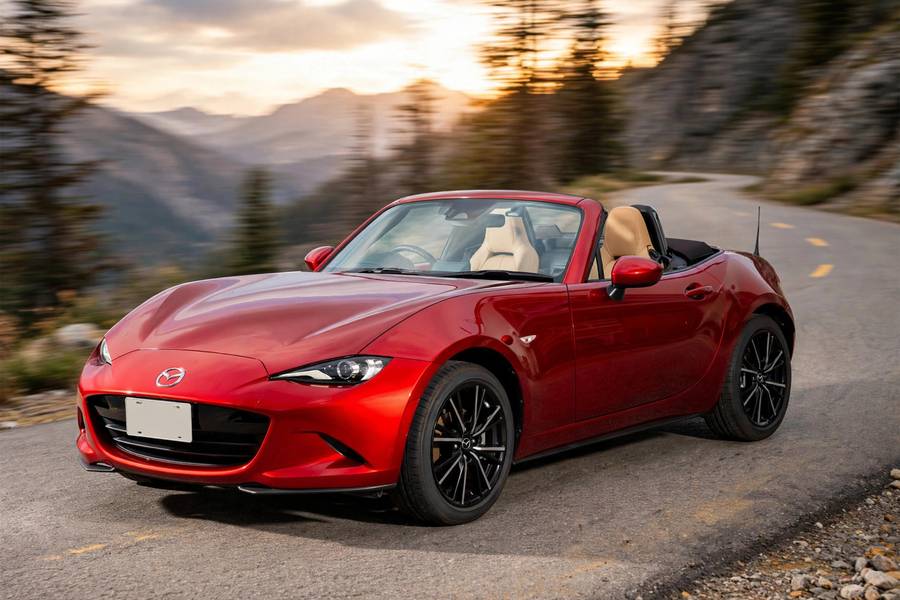 Red Mazda MX-5 Miata convertible on a mountain road, one of the best affordable sports cars