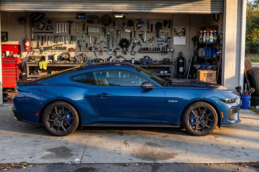 Blue Ford Mustang EcoBoost parked outside a workshop among the best affordable sports cars
