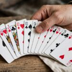 Best Card Games for Adults: The Definitive Play-Tested List Hand of playing cards fanned out on a table