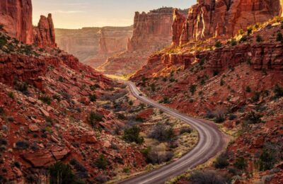 Winding road through red rock canyon on a national park road trip in Utah