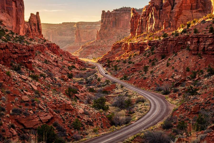 Winding road through red rock canyon on a national park road trip in Utah