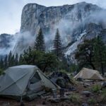 12 Best National Parks in the USA for Camping (From Tent to RV) Tent camping beneath granite cliffs in Yosemite Valley at dawn