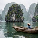 20 Best Places to Travel in the World on a Budget (2026 Guide) Ha Long Bay limestone karsts with traditional boat Vietnam