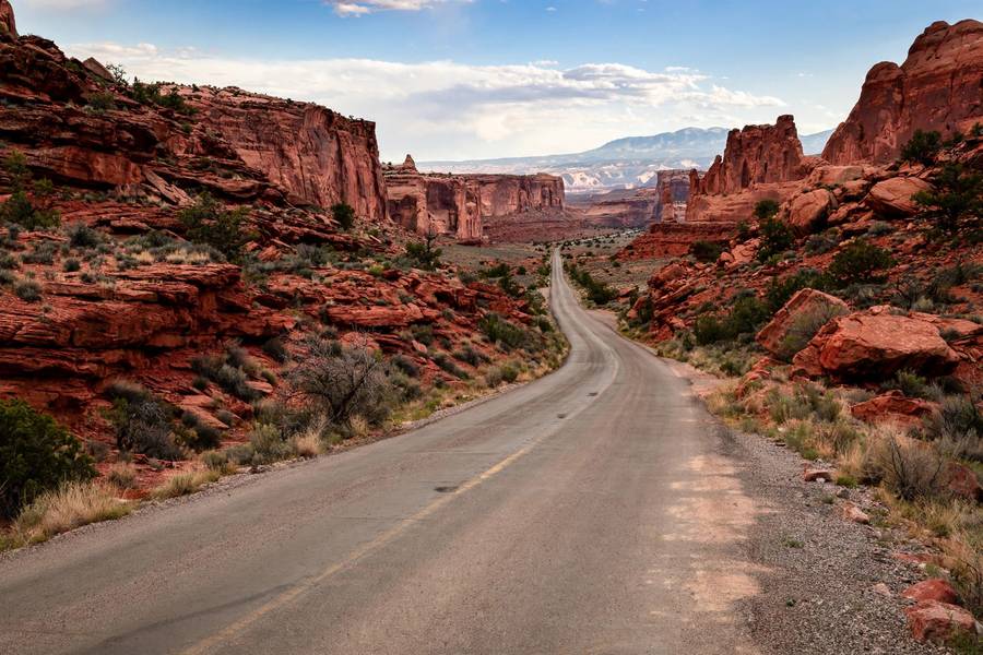 Desert road through Utah with red rock formations