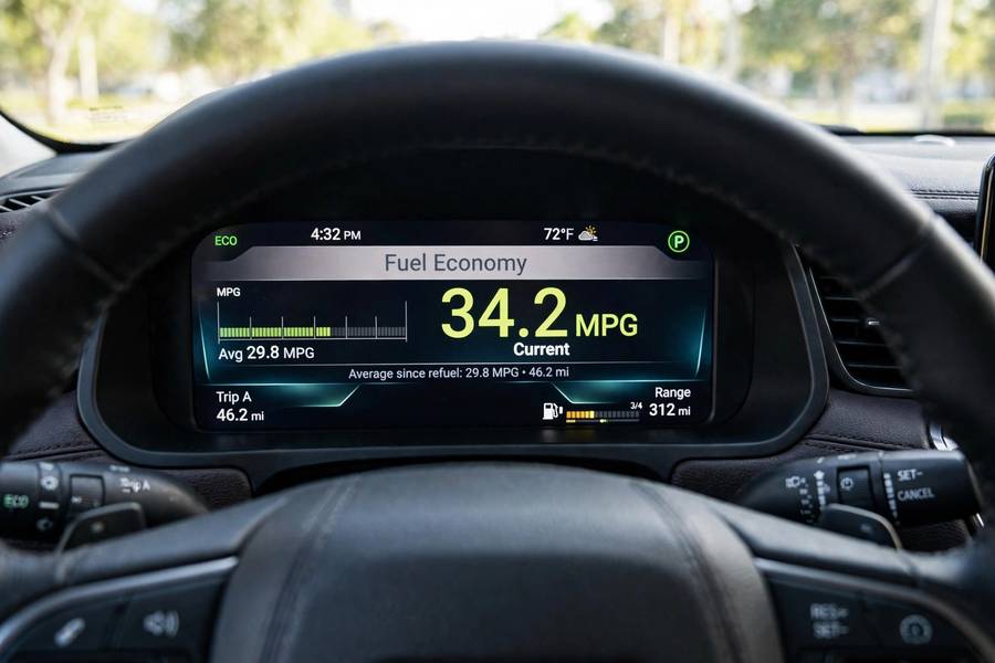 Car dashboard showing fuel economy MPG display affected by spark plug condition