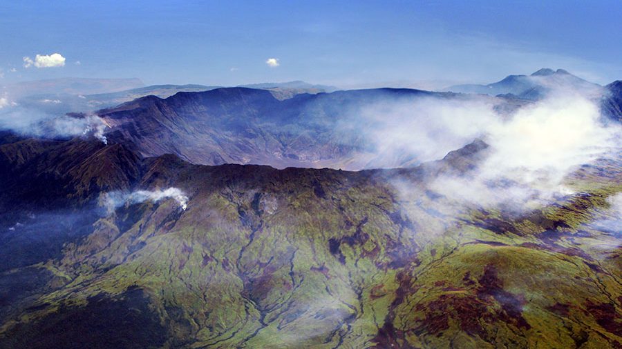 Clouds drifting across the rim of Mount Tambora's caldera, Sumbawa, Indonesia