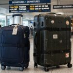 Carry On vs Checked Baggage: Which Is Right for Your Trip? Carry-on suitcase next to a large checked suitcase in an airport