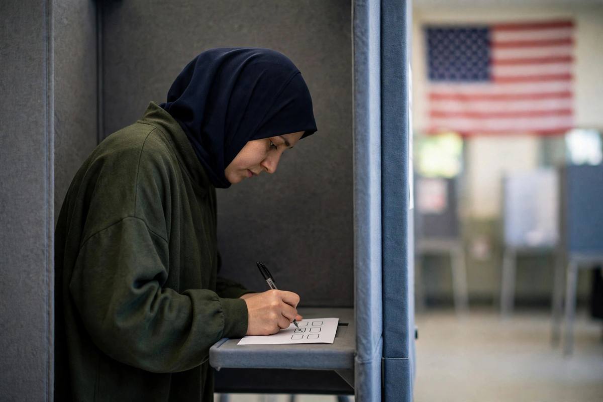 Voter marking a secret ballot inside a voting booth during a primary election