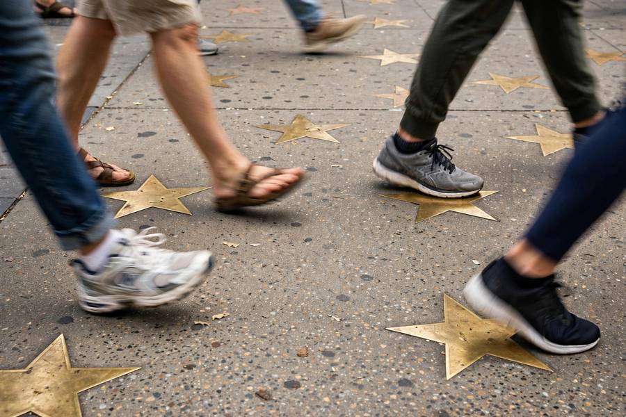 Tourists walking over stars on Hollywood Boulevard