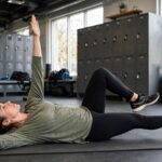 Core Strength for Runners: The Complete Coach's Guide Runner performing dead bug core exercise on a gym mat