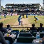 Cricket Rules for Beginners: Start Watching in 15 Minutes Cricket match in progress viewed from the stadium stands