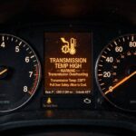 Illuminated transmission temperature warning light on a car dashboard