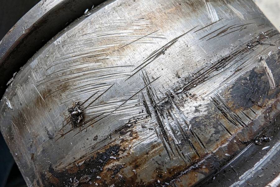 Close-up of worn CVT pulley surfaces with visible scoring