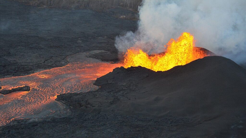 Lava fountains erupting from a cone at Kilauea, Hawaii, feeding a river of glowing lava