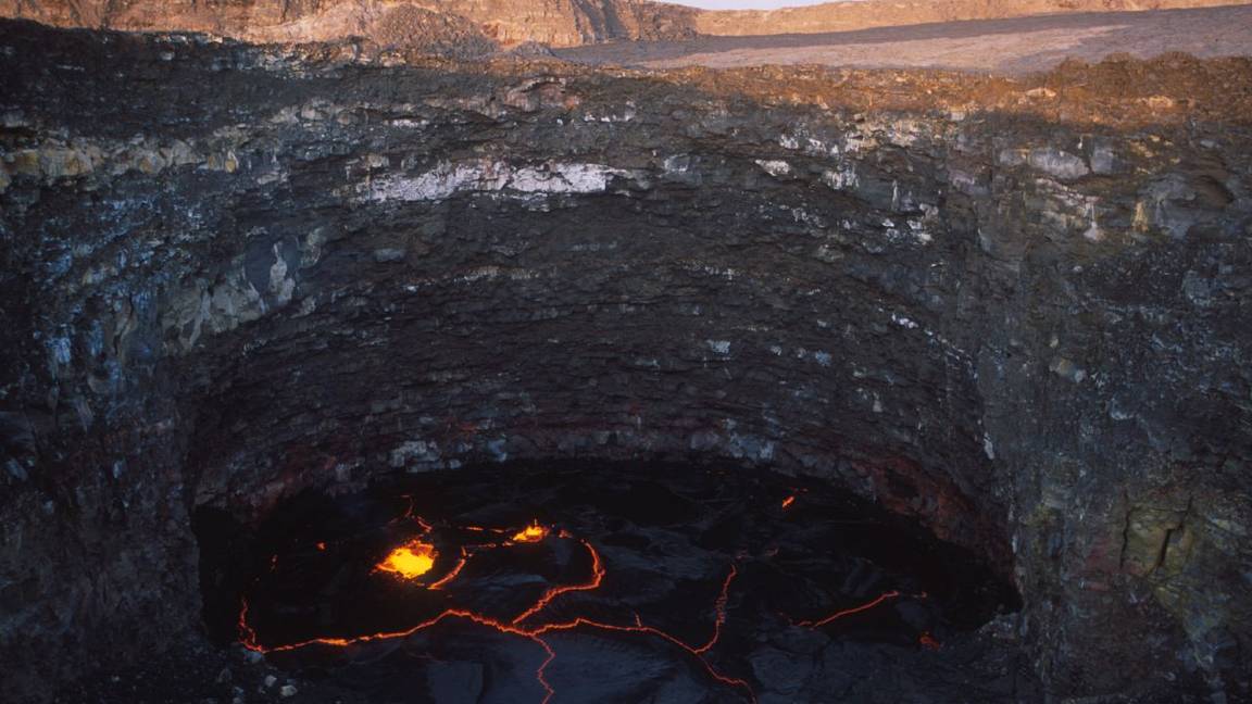 The lava lake inside Erta Ale's crater in Ethiopia, its black crust cracked by glowing molten rock