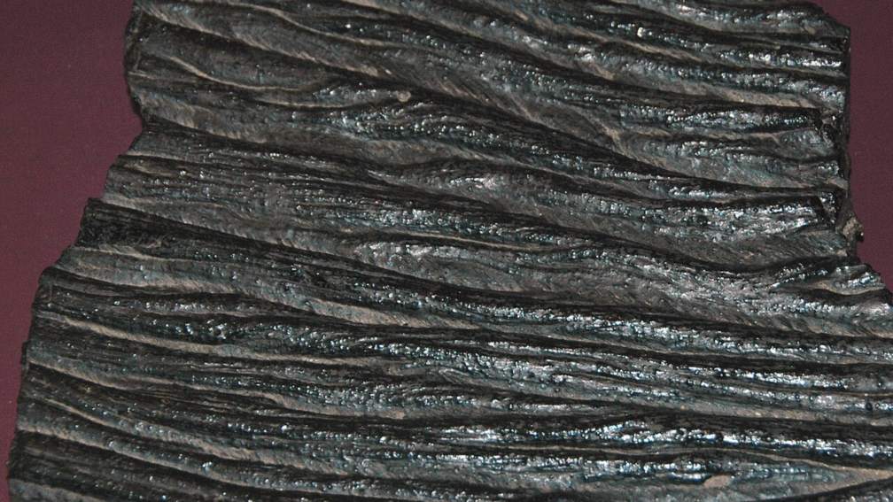 The ropy, wrinkled surface of cooled pahoehoe lava rock from Hawaii