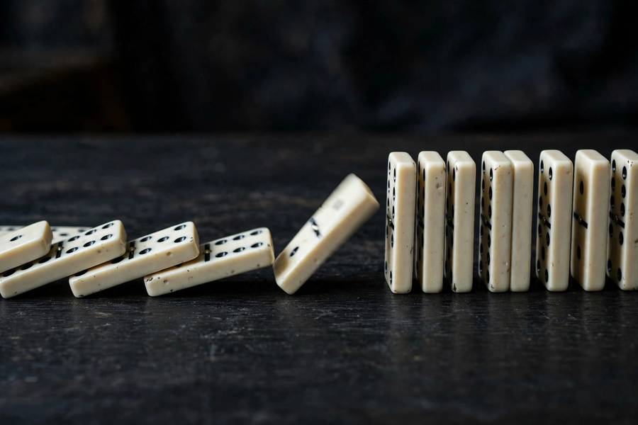Dominoes falling, symbolizing the collapse that led to the AI winter