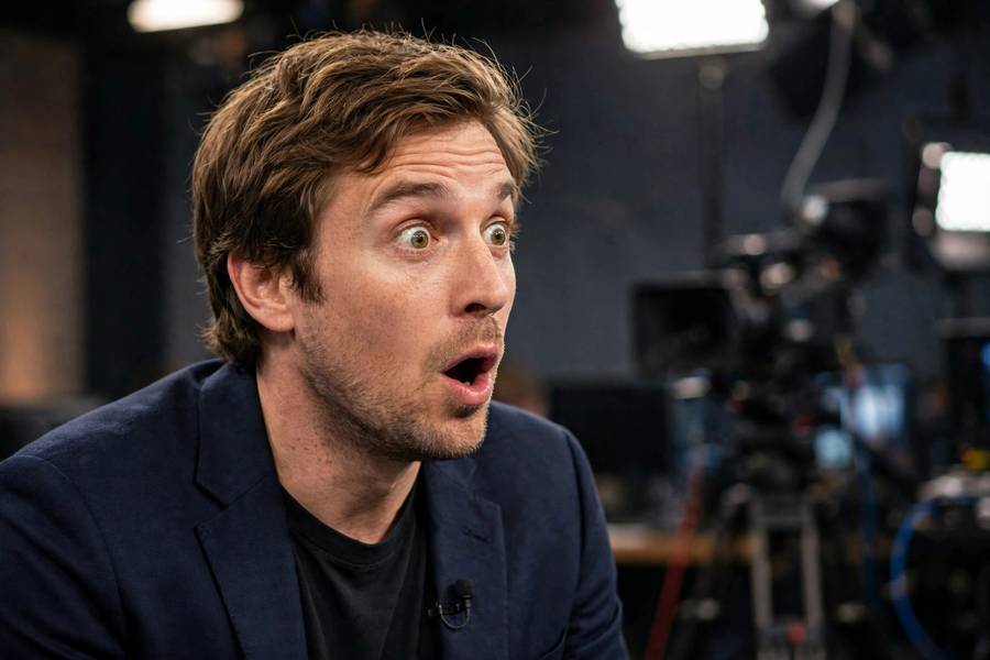 Actor surprised during live TV interview, candid funny moment, studio lights, photorealistic