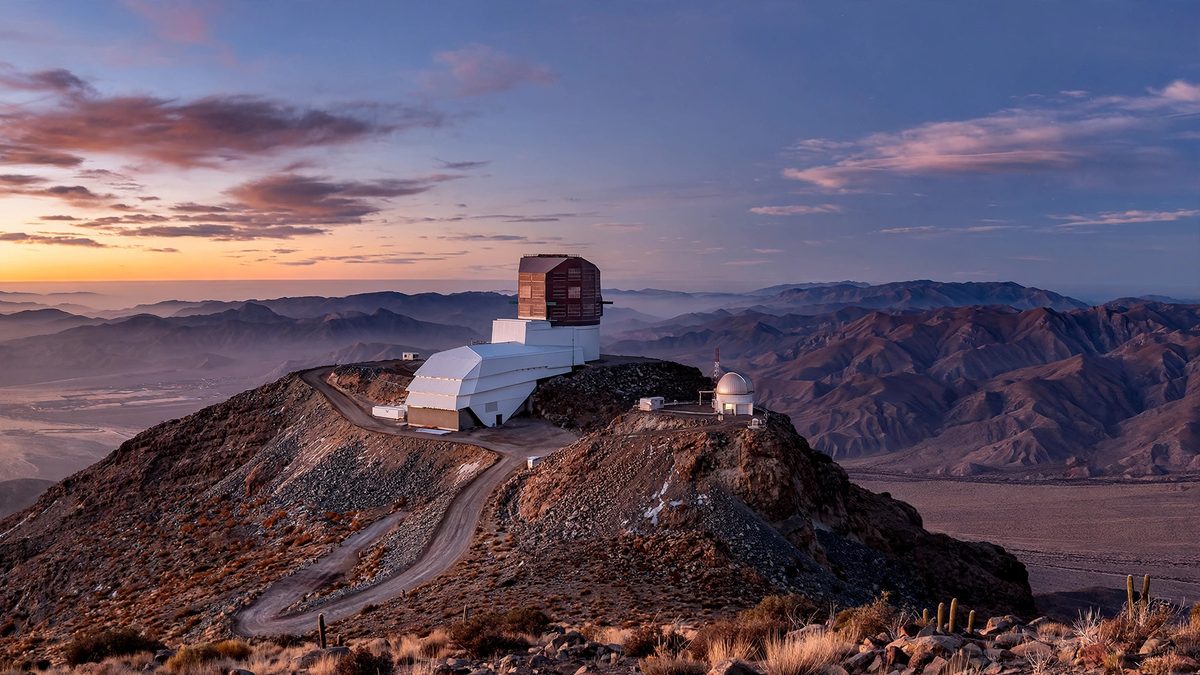 night sky over the Chilean desert with telescope domes