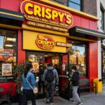 A franchise restaurant storefront with customers entering