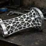 Generative Design Examples: Real Projects That Made It Work A generative design car seat bracket with an organic lattice structure, a real generative design example