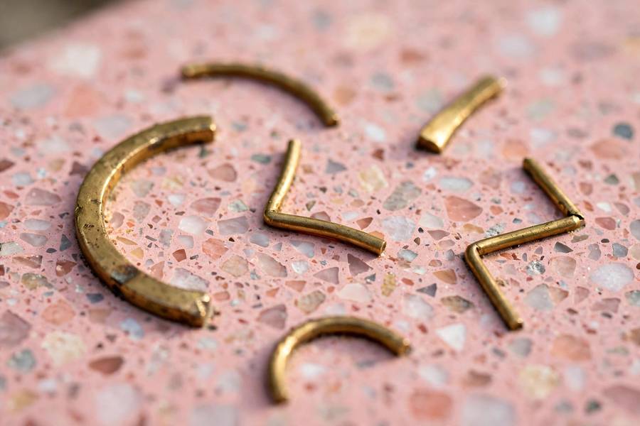 Close-up of brass star lettering set in terrazzo