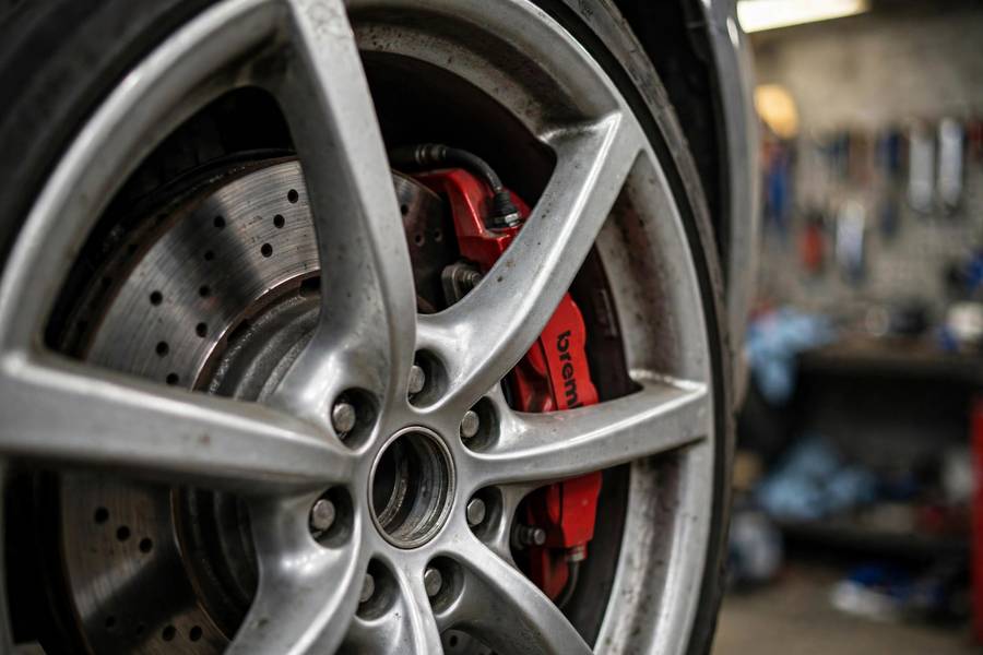 Car disc brake with drilled rotor and caliper showing how do brakes work