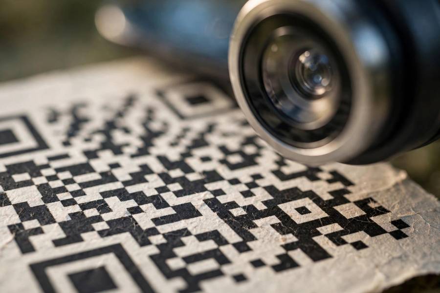 Close-up of a QR code pattern with a smartphone camera scanning it