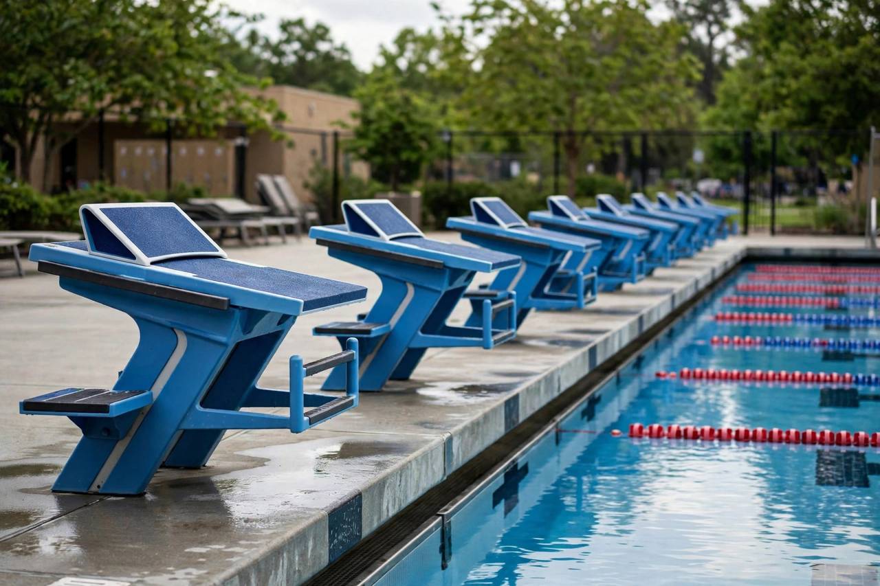 Swim meet starting blocks lined up at pool edge, no people