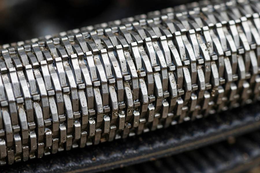 Close-up of a CVT steel push belt showing metallic segments