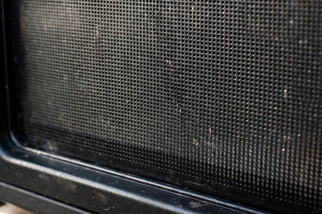 Close-up of the mesh screen on a microwave oven door