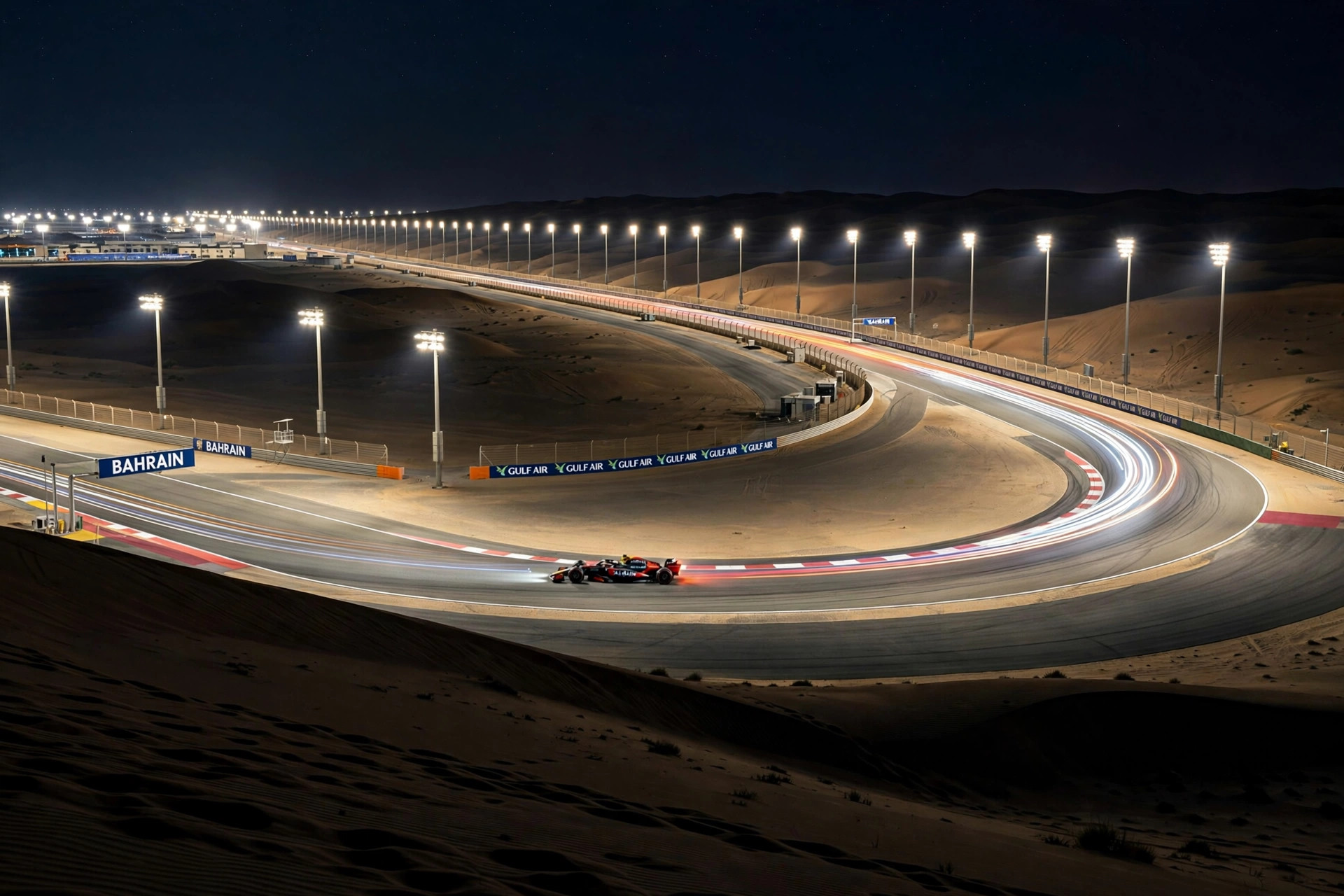 Photorealistic wide landscape of the Bahrain International Circuit at night, floodlit desert racetrack glowing against black dunes, long rows of floodlight pylons, a Formula 1 car leaving light trails through a sweeping corner, no close-up faces