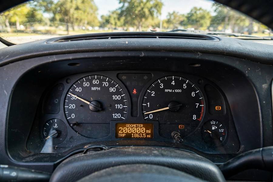 Car odometer showing over 200,000 miles on a high-mileage vehicle