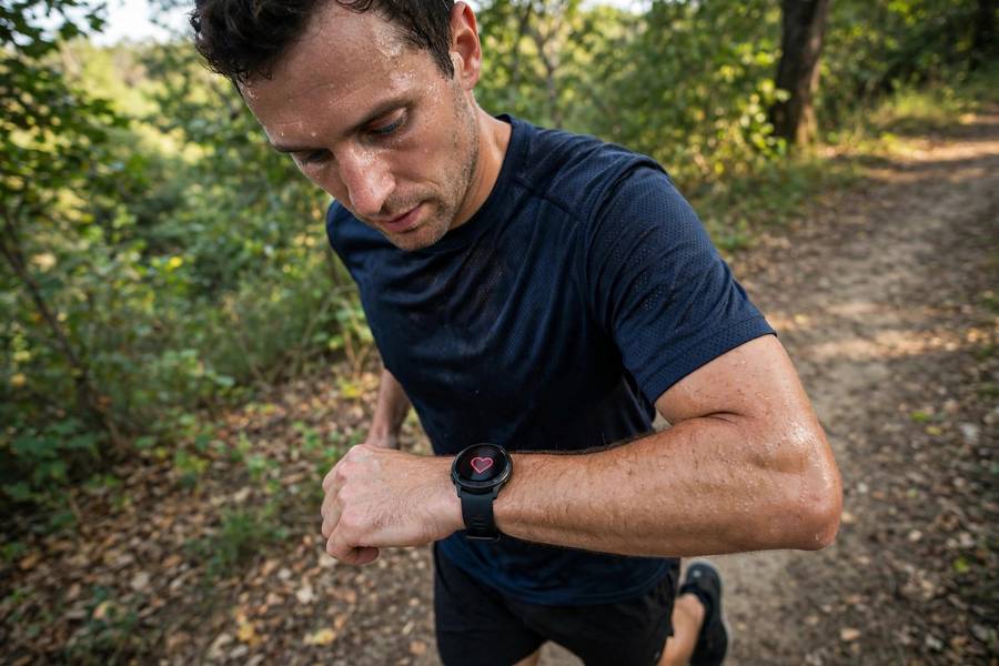 Runner tracking heart rate on sports watch during training