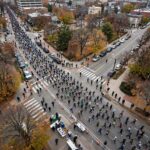 How Long Is a Marathon in Miles? (And Why That Exact Number) Aerial view of marathon runners on city streets