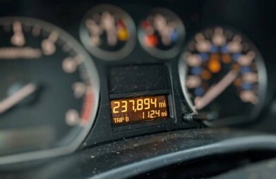 Car odometer showing high mileage on the dashboard