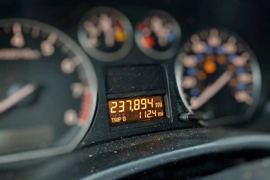 Car odometer showing high mileage on the dashboard