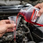 How to Add Transmission Fluid: The Right Way (Without Overfilling) Pouring transmission fluid through a funnel into the dipstick tube