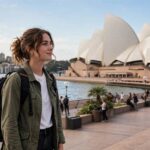 How to Apply for a Working Holiday Visa (2026 Step-by-Step) Young traveler with backpack at Sydney Opera House