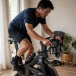 How to Build Endurance Without Running: The Complete System Person cycling on stationary bike for endurance training