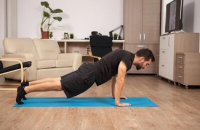 A man doing push-ups on the floor of a bright living room