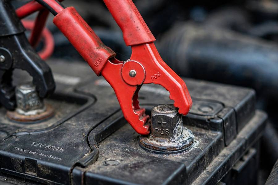 Charger clamps correctly attached when learning how to charge a car battery