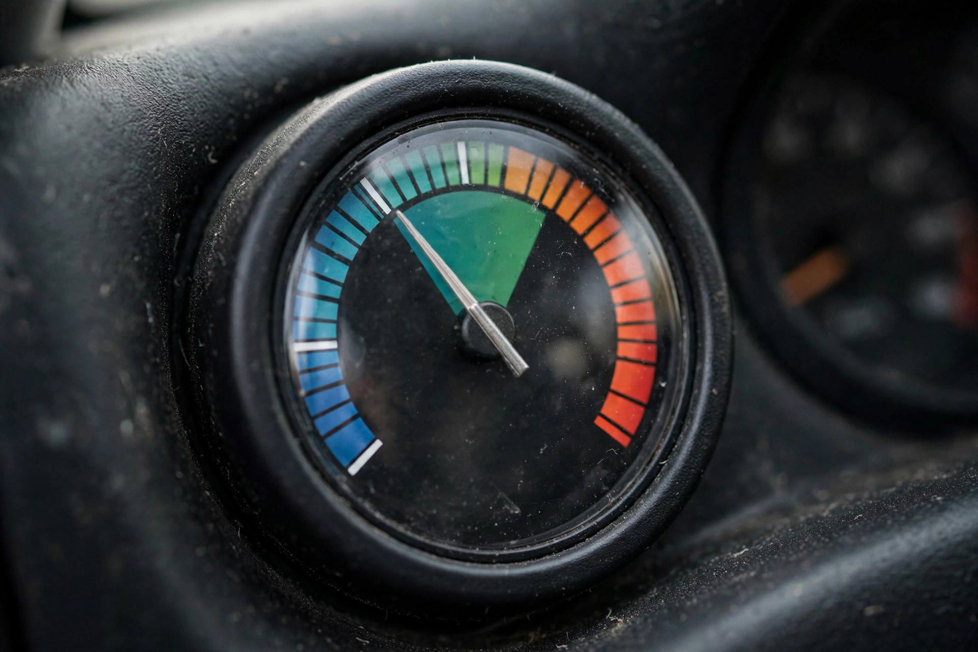 Close-up of a car temperature gauge on the dashboard showing normal operating range