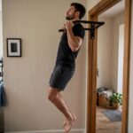 How to Do Pull Ups: From Zero to Your First Rep Man demonstrating proper pull up form with chin over the bar