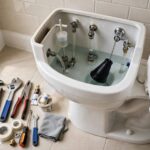 How to Fix a Running Toilet: A Step-by-Step DIY Guide Plumber tools next to an open toilet tank