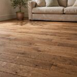 How to Fix Squeaky Floors (From Above or Below) Hardwood floor with visible boards in a home